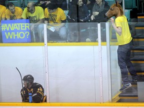Waterloo's Kirt Hill gets heckled by a Windsor Lancer fan wearing a horse head during Wednesday's game at Windsor Arena. (DAN JANISSE/The Windsor Star)