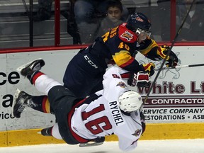 Spitfires forward Kerby Rychel, left, collides with Erie's Luke Cairns at the WFCU Centre. (JASON KRYK/ The Windsor Star)