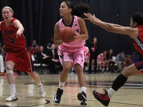 Windsor's Korissa Williams, centre, is guarded by Brock's Dayna Howlett, left, and Emily McKay at the St. Denis Centre Saturday. (DAX MELMER/The Windsor Star)