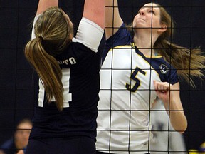 University of Windsor's Melissa Smyth, right, spikes the ball past the University of Toronto's Sarah Chapin. (TYLER BROWNBRIDGE/The Windsor Star)