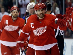 Detroit's Henrik Zetterberg, centre, is congratulated by teammates after his second goal during the first period against the St. Louis Blues. (AP Photo/Carlos Osorio)