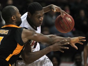Windsor's Lester Prosper, right, is guarded by London's Elvin Mims at the WFCU Centre. (DAX MELMER/The Windsor Star)