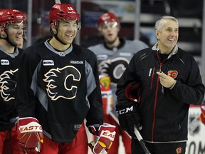 Calgary forward Jarome Iginla, left, and head coach Bob Hartley shared a laugh during a practice at the Scotiabank Saddledome in Calgary. (Colleen De Neve/Calgary Herald)