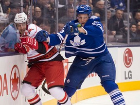 Carolina's Patrick Swyer, left, is checked by Toronto's Korbinian Holzer Monday. (THE CANADIAN PRESS/Frank Gunn)