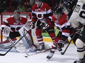 Windsor's Brady Vail, right, takes a shot on Ottawa's Jacob Blair at the WFCU Centre. (DAX MELMER/The Windsor Star)