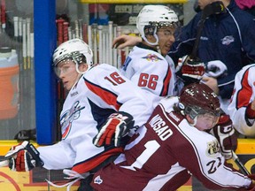 Windsor's Kerby Rychel, left, is checked by Peterborough's Stephen Nosad Thursday in Peterborough. (Peterborough Examiner photo)