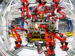 Robotic arms work on the chassis of a Fiat automobile at the company's factory near Naples, Italy, on Wednesday, Dec. 14, 2011. (Bloomberg files)