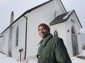 The Amherstburg First Baptist Church has recently been designated a National Historic Site. The Pastor of the church, Olaniyi Afolabi poses in front of it Friday, Feb. 22, 2013.  (DAN JANISSE/The Windsor Star)