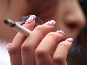 A young woman smokes a cigarette in this file photo. (Getty Images files)