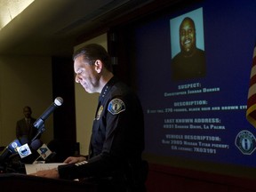 Irvine police Chief David L. Maggard announces at a news conference Wednesday, Feb. 6, 2013, in Irvine, Calif., that former Los Angeles police officer Christopher Jordan Dorner, whose image is projected at right, behind Maggard, is a suspect in the killings of Monica Quan and her fiance, Keith Lawrence, who were found shot to death in their car at a parking structure Sunday night. (AP Photo/The Orange County Register, Cindy Yamanaka)