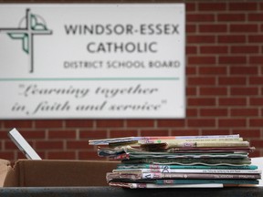 Boxes of school books sit in dumpsters outside the former St. Theresa Catholic School in Amhersburg, Ont., Monday, February 11, 2013.  (DAX MELMER/The Windsor Star)