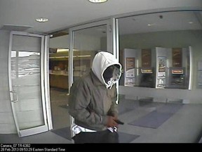 A surveillance camera image of a man who robbed a CIBC branch in LaSalle, Ont. on Feb. 28, 2013. (Handout / The Windsor Star)