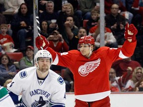 Detroit's Damien Brunner, right, celebrates a goal by Daniel Cleary while Vancouver's Keith Ballard, left, reacts Sunday, Feb. 24, 2013, in Detroit. (AP Photo/Duane Burleson)