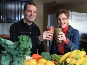 Andrew Facca, left,and Jackie McCreary toast to a new 30-day wellness challenge that helps people feel better overall through small changes in diet, exercise, and spiritual awareness.  (JASON KRYK / The Windsor Star)