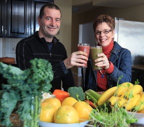Andrew Facca, left,and Jackie McCreary toast to a new 30-day wellness challenge that helps people feel better overall through small changes in diet, exercise, and spiritual awareness.  (JASON KRYK / The Windsor Star)