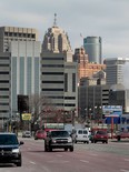 The city skyline stands as cars drive down a street in Detroit, Mich., on Feb. 21, 2013. (Jeff Kowalsky/Bloomberg)