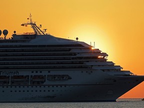 The cruise ship Carnival Triumph is towed into Mobile Bay near Dauphin Island, Ala., Thursday, Feb. 14, 2013. The ship with more than 4,200 passengers and crew members has been idled for nearly a week in the Gulf of Mexico following an engine room fire. (AP Photo/Dave Martin)