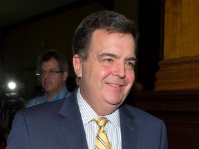 Former Windsor-Tecumseh MPP Dwight Duncan smiles as he leaves his final press conference as Ontario's Finance Minister on Feb. 7, 2013. Photographed at Queen's Park, Toronto. (Frank Gunn / Canadian Press)