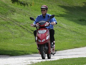 An E-biker zips along a Windsor, Ont. waterfront Thursday, Aug. 25, 2011.  (DAN JANISSE/The Windsor Star)