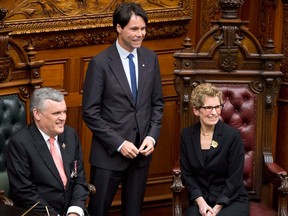 Ontario Lieut.-Gov. David Onley and Premier Kathleen Wynne pose with Eric Hoskins at a swearing-in ceremony at Queen's Park in Toronto on Monday, Feb. 11, 2013. (THE CANADIAN PRESS/Frank Gunn)