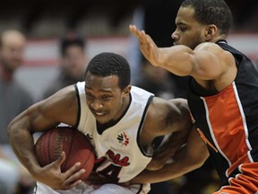 Windsor's Stefan Bonneau, left, drives past by Oshawa's Larry Diamond during their game Wednesday, Feb. 6, 2013, at the WFCU Centre in Windsor. The Express won127-93. (DAN JANISSE/The Windsor Star)