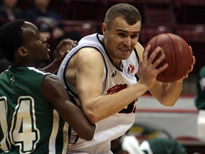 Windsor's Greg Surmacz, right, collides with the Montreal's Damian Buckley at the WFCU Centre in Windsor Wednesday, February 20, 2013. (TYLER BROWNBRIDGE/The Windsor Star)