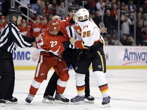 Detroit Red Wings right wing Jordin Tootoo (22) and Calgary Flames center Steve Begin (25) fight during the first period of an NHL hockey game in Detroit, Tuesday, Feb. 5, 2013. (AP Photo/Paul Sancya)