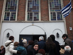 Members of Windsor's Greek community wait in line outside the Holy Cross Greek Orthodox Church, Sunday, February 24, 2013, to attend a meeting to discuss the Mayor's proposal of a local Greektown at the former Grace Hospital site. (DAX MELMER/The Windsor Star)