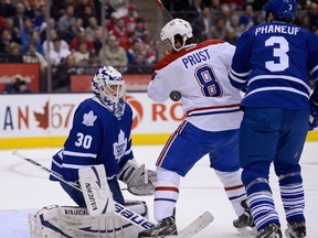 Toronto goalie Ben Scrivens, left, looks for the puck as Montreal's Brandon Prust, centre, and Toronto's Dion Phaneuf battle in front of his net during NHL action in Toronto Wednesday Feb. 27, 2013. (THE CANADIAN PRESS/Frank Gunn)