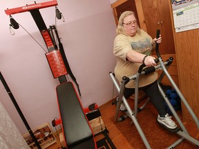 Geri Robitaille works out in her home gym at her home in Windsor Wednesday, February 27, 2013. Robitaille has managed to increase her health with lifestyle changes rather than medication. (TYLER BROWNBRIDGE/The Windsor Star)