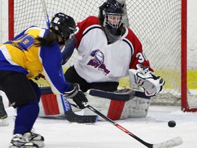 Holy Names goalie Lorna Pelletier, right, makes a save on St. Anne's Jessica Gaudette during the WECSSAA girls AAA/AAAA hockey final at South Windsor Arena Wednesday, February 27, 2013. (TYLER BROWNBRIDGE/The Windsor Star)