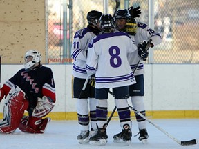 Cardinal Carter goalie Brandon Lavadan, left, reacts as Assumption's Garrick Loewen, Chris Zajner and Andrew Aversa celebrate a goal during an outdoor hockey game at Lanspeary Park in Windsor Wednesday, February 13, 2013. (TYLER BROWNBRIDGE/The Windsor Star)