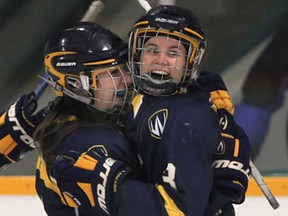 Windsor's Candice Chevalier, left, and Ally Strickland celebrate a goal during game Game 1 of their OUA playoff series against Queen's Thursday, Feb. 14, 2013, at the South Windsor Arena. The Lancers won 6-1. (DAN JANISSE/The Windsor Star)