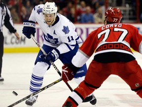 Carolina's Joe Corvo, right, defends against Toronto's Jay McClement during the first period in Raleigh, N.C., Thursday, Feb. 14, 2013. (AP Photo/Gerry Broome)