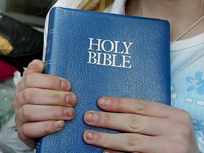 A girl holds the Holy Bible. (Windsor Star files)