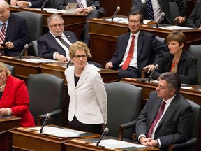 Ontario Premier Kathleen Wynne speaks from the floor after Lieutenant Governor David Onley delivered the throne speech at the Ontario Legislature in Toronto on Tuesday February 19, 2013, THE CANADIAN PRESS/Chris Young