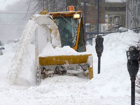 A sidewalk gets cleared in P.E.I. on Feb. 10, 2013. (Canadian Press photos)