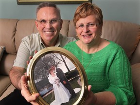 Greg and Kathy Peifer at their Lasalle  home with their wedding day photo. They plan on renewing their wedding vows on Valentines Day.  (DAN JANISSE/The Windsor Star