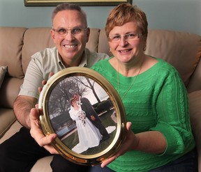 Greg and Kathy Peifer at their Lasalle  home with their wedding day photo. They plan on renewing their wedding vows on Valentines Day.  (DAN JANISSE/The Windsor Star