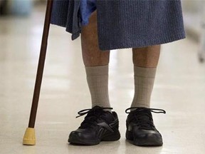 An elderly person walks in a hall at Sunnybrook Hospital in Toronto on Friday, January 20, 2012.  (THE CANADIAN PRESS/Pawel Dwulit)