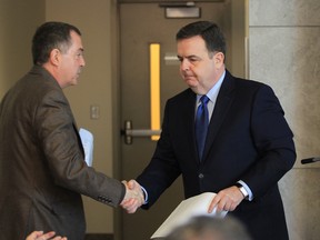 Ontario Minister of Finance Dwight Duncan, right, shakes hands with Dave Cooke from the community consultation committee for a state-of-the-art, single site hospital to serve Windsor-Essex. (JASON KRYK/The Windsor Star)