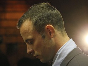Olympic athlete Oscar Pistorius stands in the dock during his bail hearing at the magistrates court in Pretoria, South Africa, Friday, Feb. 22, 2013. (AP Photo/Themba Hadebe)