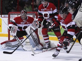 Windsor's Brady Vail, right, shoots on Ottawa's Jacob Blair earlier this season at the WFCU Centre, Sunday, Dec. 2, 2012. The Spitfires lost 8-5 to the 67's Saturday in Ottawa. (DAX MELMER/The Windsor Star)