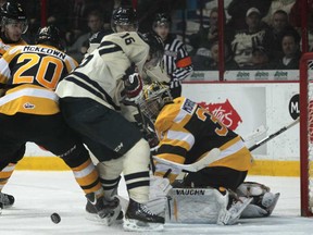 Windsor's Kerby Rychel, centre, scrambles in front of the Kingston net earlier this season at the WFCU Centre. Rychel scored in a 3-1 loss the the Frontenacs Sunday in Kingston.  (DAX MELMER/The Windsor Star)