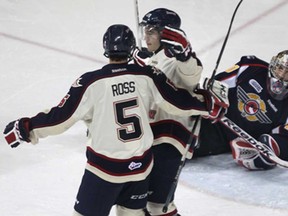 Windsor's goalie Jordan DeKort, left, looks on as Saginaw's Garret Ross, left, and ex-Spit Eric Locke celebrate a goal, Monday, Feb. 18, 2013 at the WFCU Centre in Windsor. The Spirit defeated the Spitfires 4-2. (DAN JANISSE/The Windsor Star)