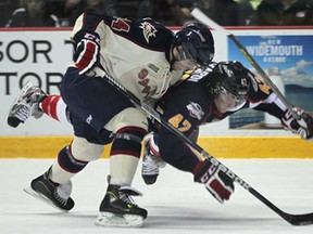 Saginaw's Steven Strong, left, and Windsor's Alex Aleardi collide Monday, Feb. 18, 2013, at the WFCU Centre in Windsor. The Spirit beat the Spitfires 4-2. (DAN JANISSE/The Windsor Star)