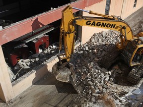 Old printing presses can be seen on the left while an excavator with Gagnon Demolition tears down a portion of the wall at the former Windsor Star building in downtown Windsor, Ont., Monday, February 25, 2013.   (DAX MELMER/The Windsor Star)