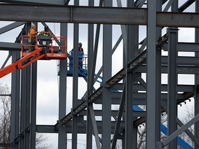 Construction crews raise the steel that will make up the new sportsplex at St. Clair College in Windsor on Friday, February 15, 2013.           (TYLER BROWNBRIDGE / The Windsor Star)