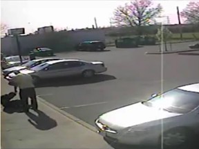 A screen grab of surveillance video footage showing Det. David Van Buskirk's beating Dr. Tyceer Abouhassan in the parking lot of the Jackson Park Health Centre in Windsor, Ont., April 22, 2010.