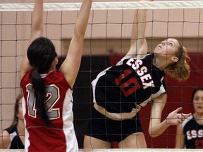 Essex's Emily McCloskey, right, spikes the ball past Brennan's Andrea Bisutti during the WECSSAA volleyball semifinal at Essex Thursday, Feb. 14, 2013. (TYLER BROWNBRIDGE/The Windsor Star)